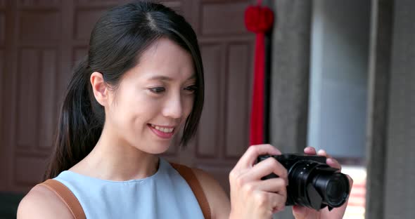 Woman taking video on camera in Chinese temple