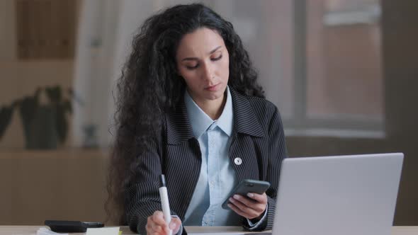 Concentrated Female Hispanic Businesswoman Student Worker Using Mobile App Search Information Online