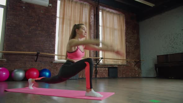 Fit Woman Working Out High Lunge Exercise Indoors