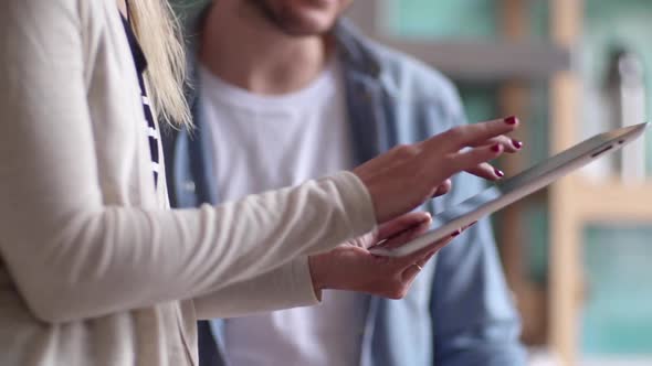 Couple using digital tablet to shop online