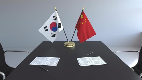 Flags of South Korea and China on the Table