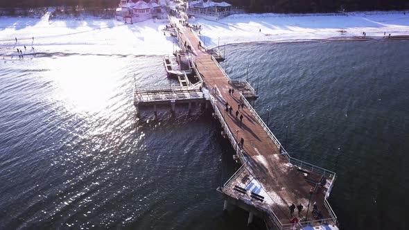 Gdansk Brzezno pier in winter, aerial shot. Flying along the side of the pier. Sunny winter day. Gda