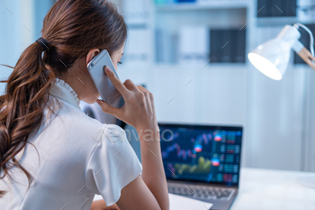 market and graph in office. Business woman call center use mobile phone give money plan management and analysis to customer in workplace late night.
