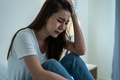 Asian beautiful depression girl crying in tears sit on bed in bedroom. - PhotoDune Item for Sale