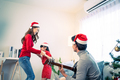 Asian lovely family member enjoy sing Christmas song together at home. - PhotoDune Item for Sale