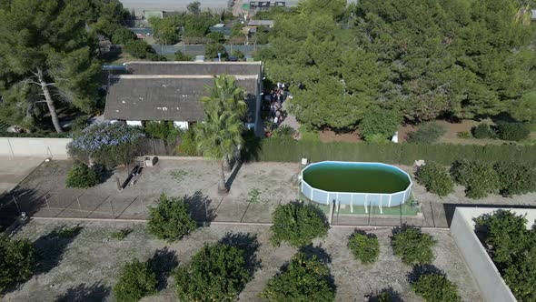 Aerial Backward Movement of a Village By the Side of a Canal By the Lake with the View of Houses