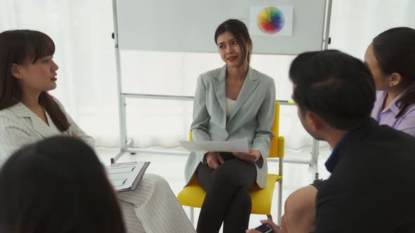 Business People Proficiently Discuss Work Project While Sitting in Circle