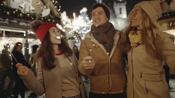 Laughing Group of Friends Having Fun at the Christmas Fair