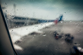 airplane wing through passenger window with rain drops - PhotoDune Item for Sale