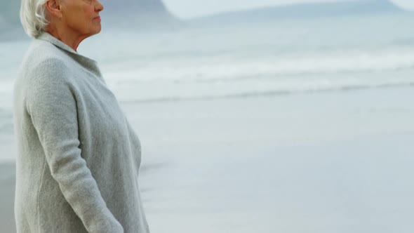 Senior woman walking on beach