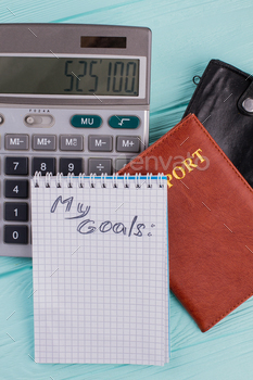 mber on the calculator and passport is a symbol of the price of travel.
