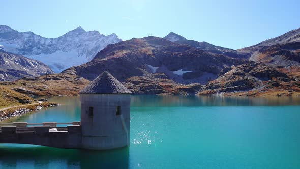 Glistening Blue Water Of Weisssee Lake And Reservoir On A Sunny Day With Panorama Of Mountain In Aus
