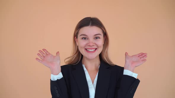 Happy Adorable Woman with Brunette Hair in Black Jacket Opening and Covering Her Face with Hands