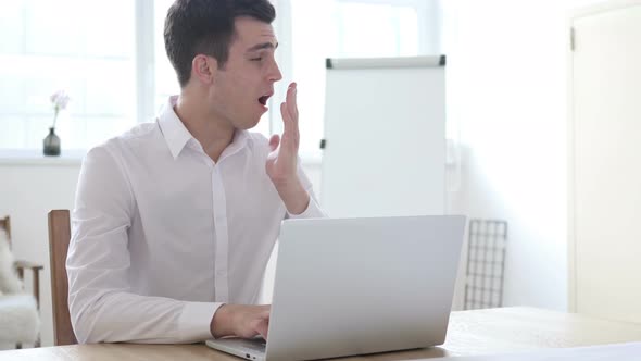 Yawning Tired Businessman Working in Office