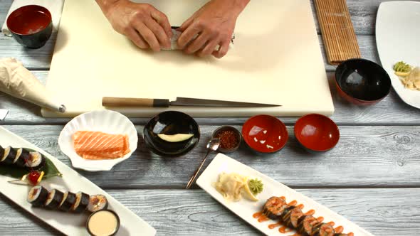 Man's Hands Cook Sushi