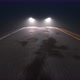Car with Headlights on Follows Camera Tracking along Country Night Road - VideoHive Item for Sale