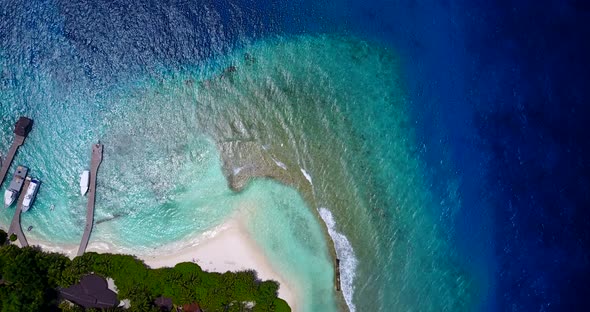 Beautiful flying abstract view of a white sandy paradise beach and turquoise sea background 