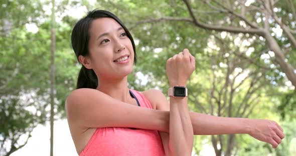 Young sport woman stretching arm 