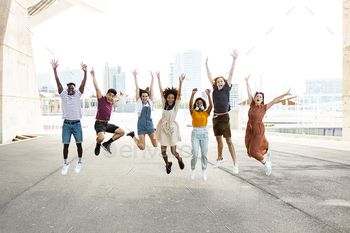 Happy multiracial people jumping together outdoors
