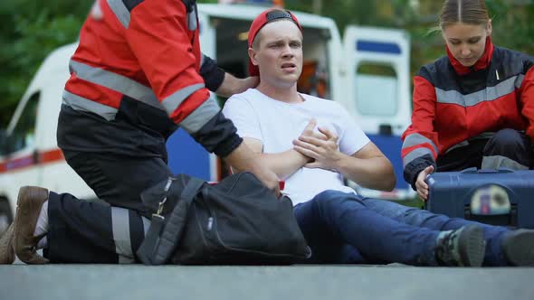 Paramedics Caring for Man Suffering From Chest Pain, Qualified Medical Care