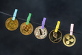 Cryptocurrencies hanging on rope with clothes pins - PhotoDune Item for Sale