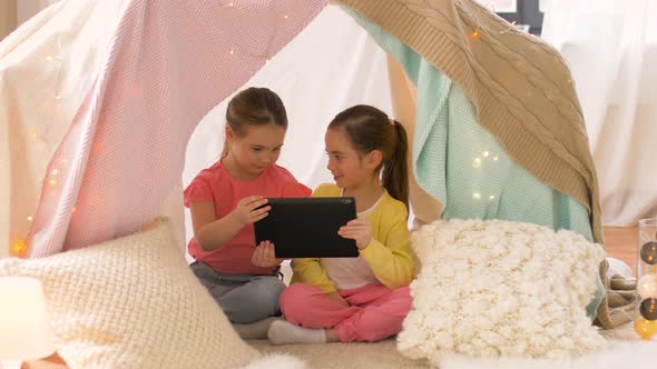 Little Girls with Tablet Pc in Kids Tent at Home