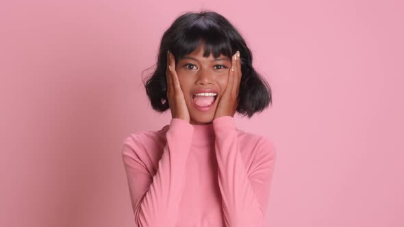 Positive Young Mixed Race Woman Stares with Surprisement Smiles Broadly