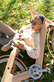 Cheerful woman with book lying on grass near bicycle - PhotoDune Item for Sale