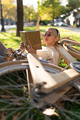 Relaxed woman lying on bicycle and reading book - PhotoDune Item for Sale
