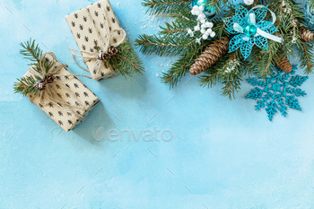  box and christmas decor on a blue stone background for your greeting card. Top view flat lay with space for text.