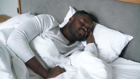 Handsome man sleeping in bed