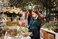 Young woman in medical face mask enjoying New Year shopping, walking in home decor department - PhotoDune Item for Sale
