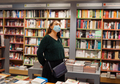 Young lady in face mask stands in bookstore during covid19 outbreak - PhotoDune Item for Sale