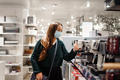 Cheerful lady in face mask chooses coffee machine in shopping mall during covid19 pandemic - PhotoDune Item for Sale