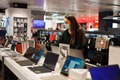Young woman in medical face mask choosing laptop in tech store during Covid-19 pandemic - PhotoDune Item for Sale