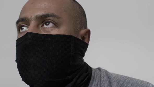 Adult UK Asian Male Wearing Balaclava Indoors Looking Forwards. Locked Off, Low Angle