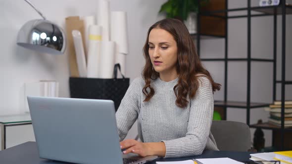 Irritated Businesswoman Closing the Laptop Computer with Anger