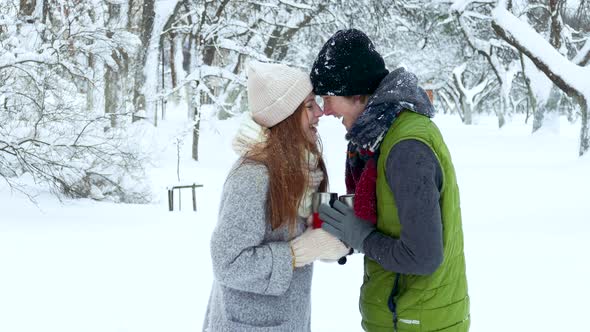 Couple Drinking Tea Coffee Cup in the Winter