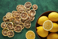 Dried Lemons on a Green Background with Fresh Lemons in a Wooden Bowl. - PhotoDune Item for Sale