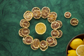 Dried Lemons on a Circle on a Green Background with Fresh Lemons in a Wooden Bowl - PhotoDune Item for Sale