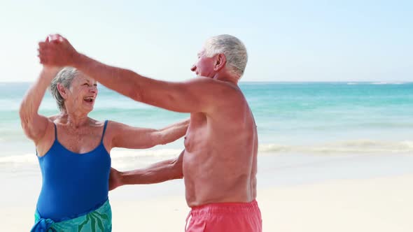 Old retired couple dancing together