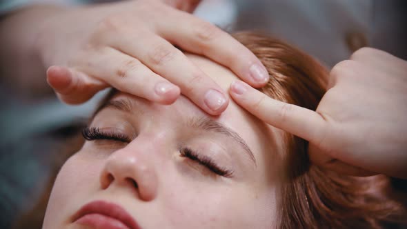 Massage - Massage Master Massaging Womans Forehead with Special Technique Using Fingers