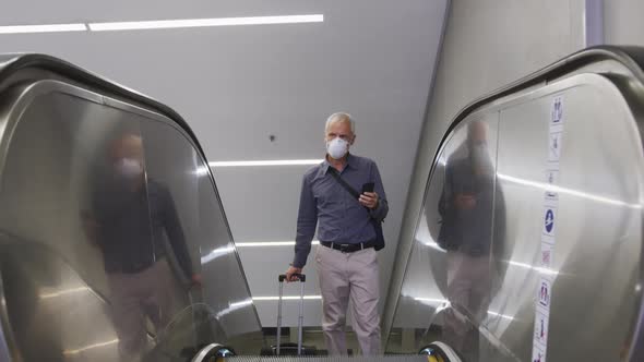 Caucasian man out and about in a metro station wearing on a face mask against coronavirus