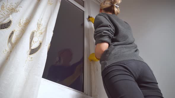 A woman washes the walls from mold in the apartment. Housewife.