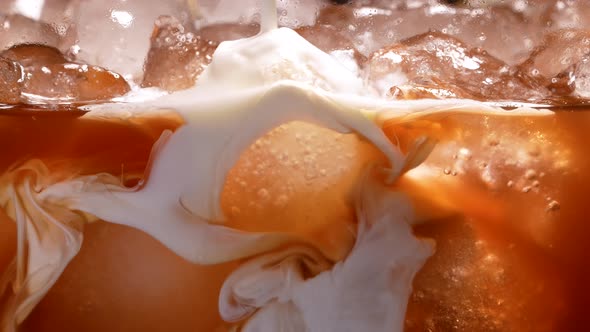 Milk Cream is Poured Into Iced Coffee in Slow Motion