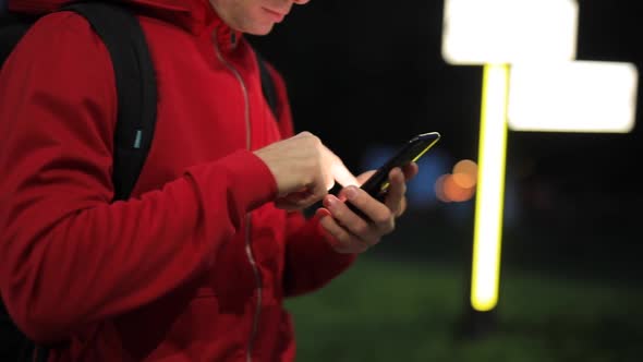 Unrecognizable Person with Smartphone in the Park