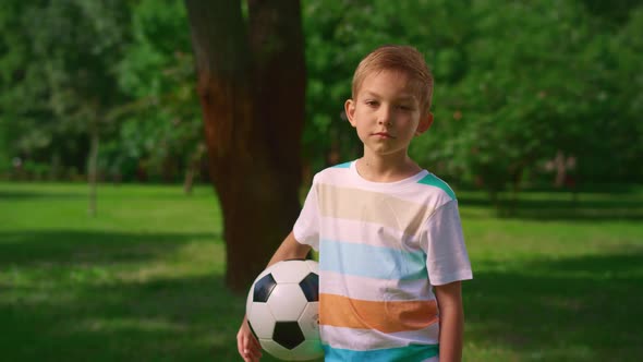 Boy with Soccer Ball Posing Camera on Nature