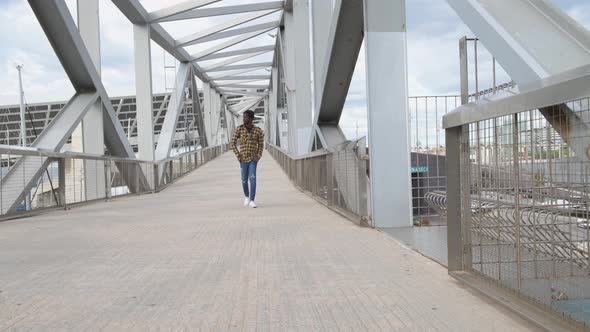 black man walking on a metal structure