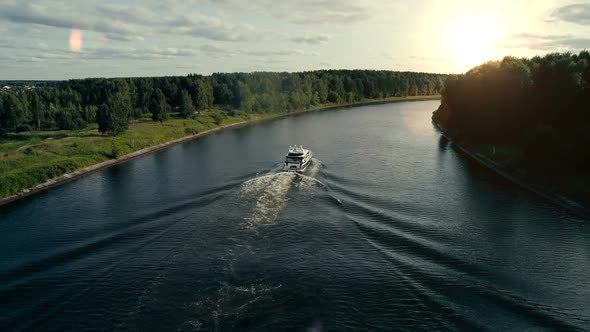 A Motor Boat Floats on the River To the Sunset