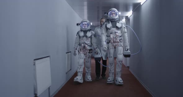 Astronauts Walking Down a Corridor